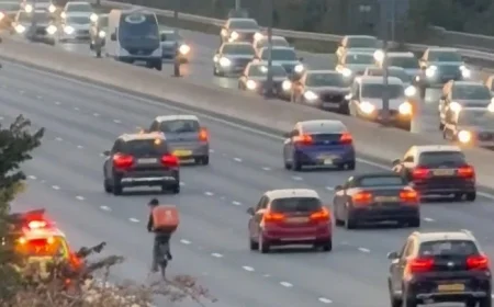 Delivery Cyclist on Just Eat Mission Causes Stir by Pedaling Through M4 Rush Hour Traffic Until Stopped by Traffic Officers