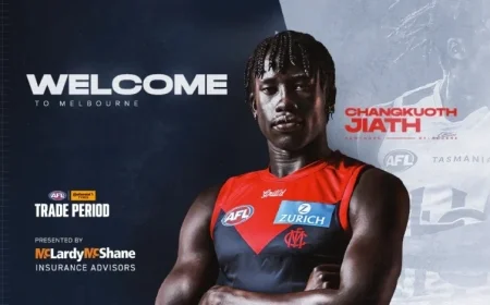 CJ signs with the red and blue team