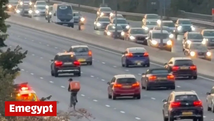 Delivery Cyclist on Just Eat Mission Causes Stir by Pedaling Through M4 Rush Hour Traffic Until Stopped by Traffic Officers